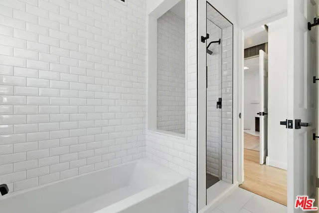 an empty room with wooden floor and a fireplace