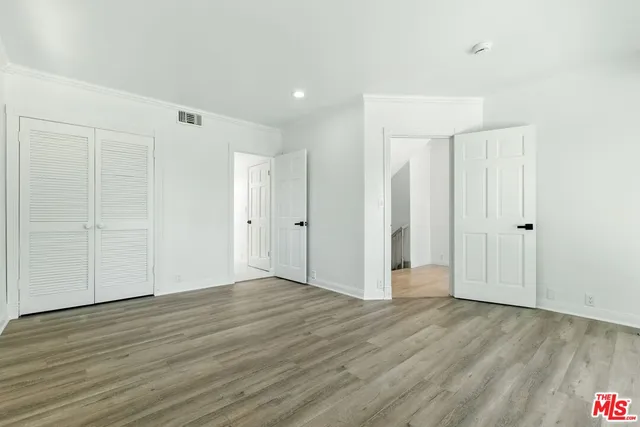 an empty room with a fireplace and wooden floor