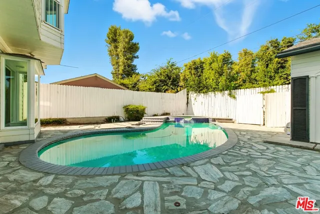 a view of a house with swimming pool and sitting area