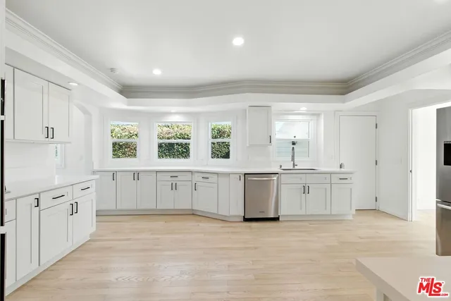 a large kitchen with cabinets and stainless steel appliances