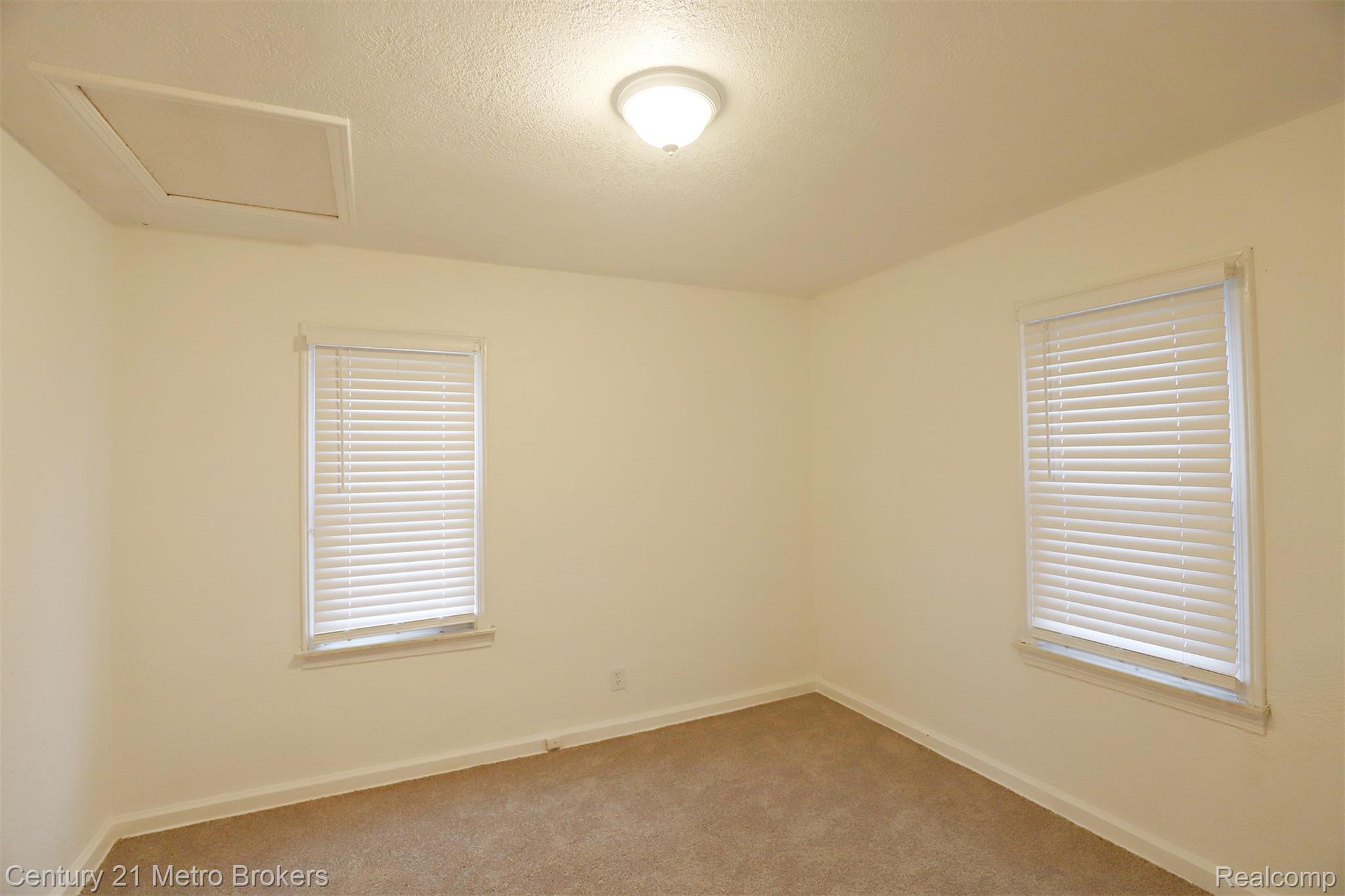 2074 North Center Road Burton, MI 48509 - Photo 14 of 20 Spare room featuring a textured ceiling and carpet flooring