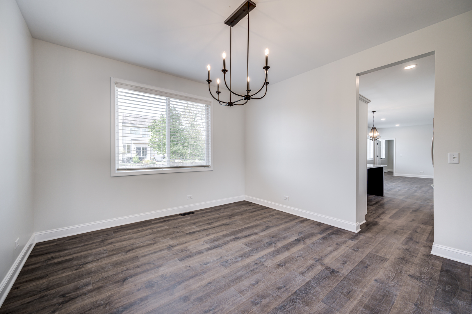 12948 Parterre Place Plainfield, IL 60585 - Photo 10 of 35 a view of an empty room with wooden floor and a window