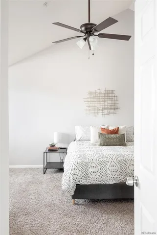 a bedroom with a bed a chandelier and a window