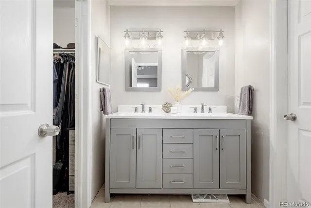 a bathroom with a sink vanity and a mirror