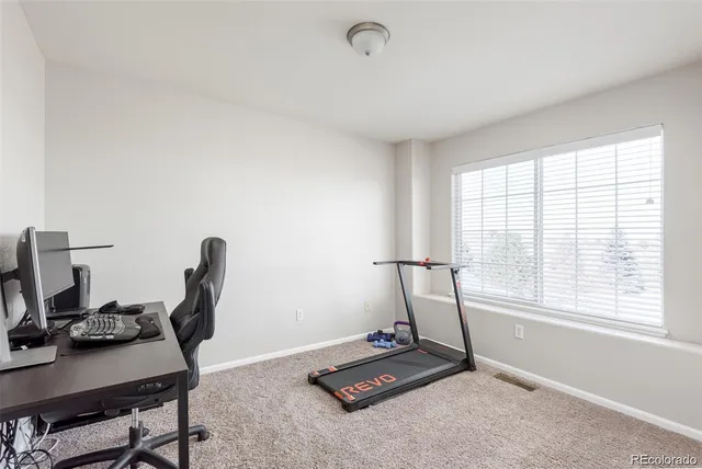 a room with gym equipment and a window