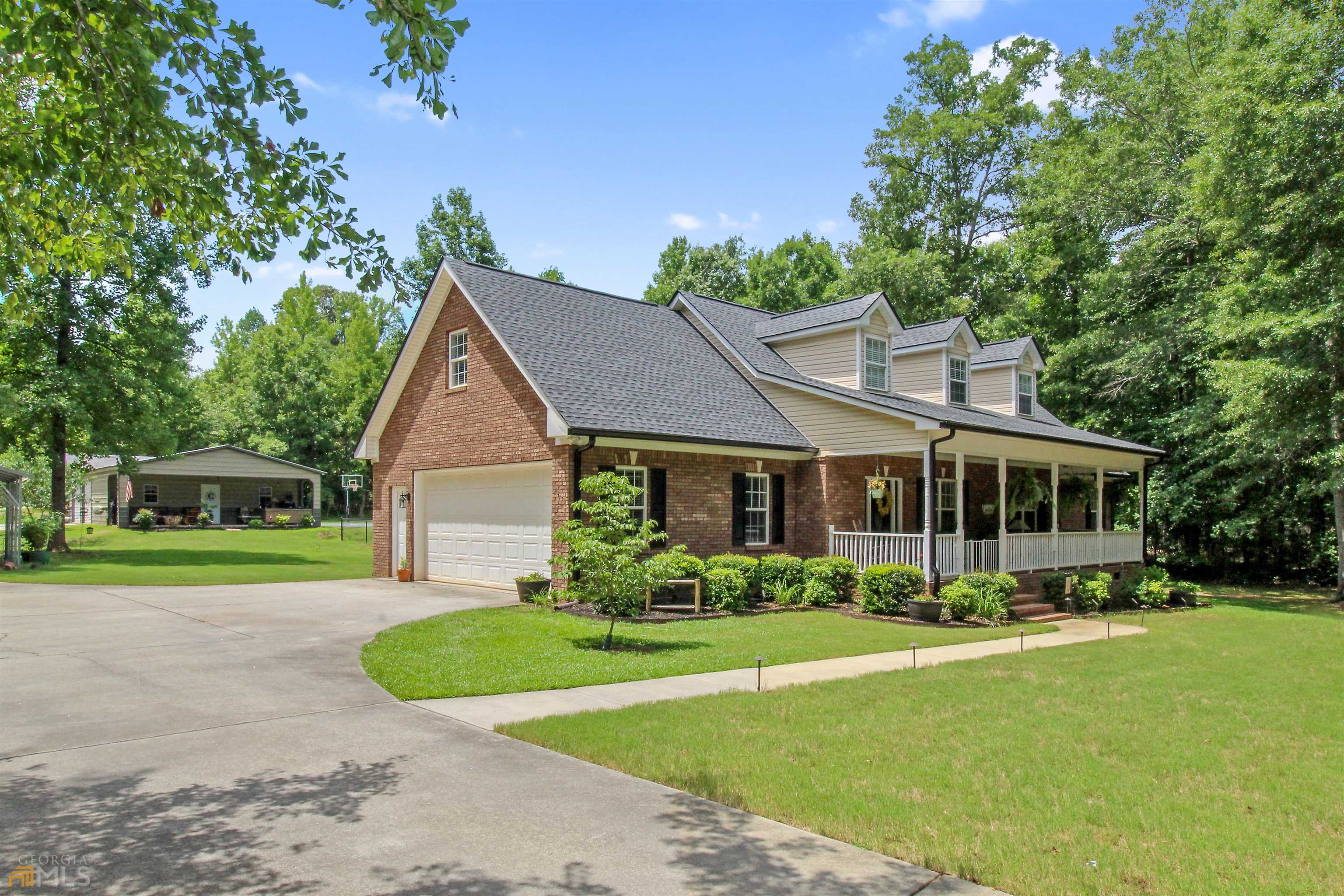 164 Strickland Pasture Road Jackson, GA 30233 - Photo 1 of 1 a front view of a house with a yard and potted plants