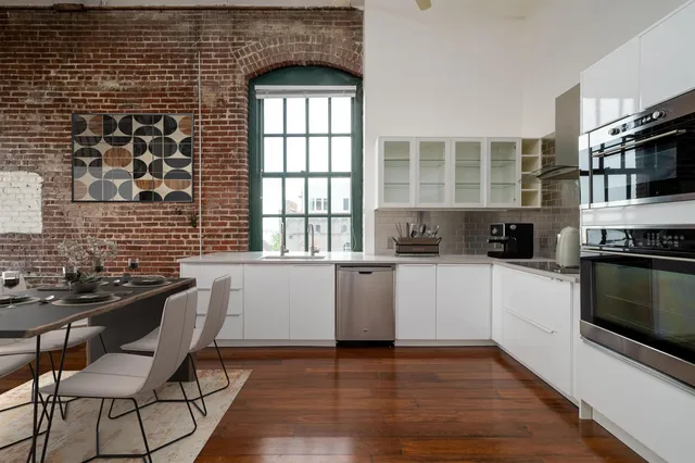 a kitchen with stainless steel appliances a refrigerator and a stove top oven