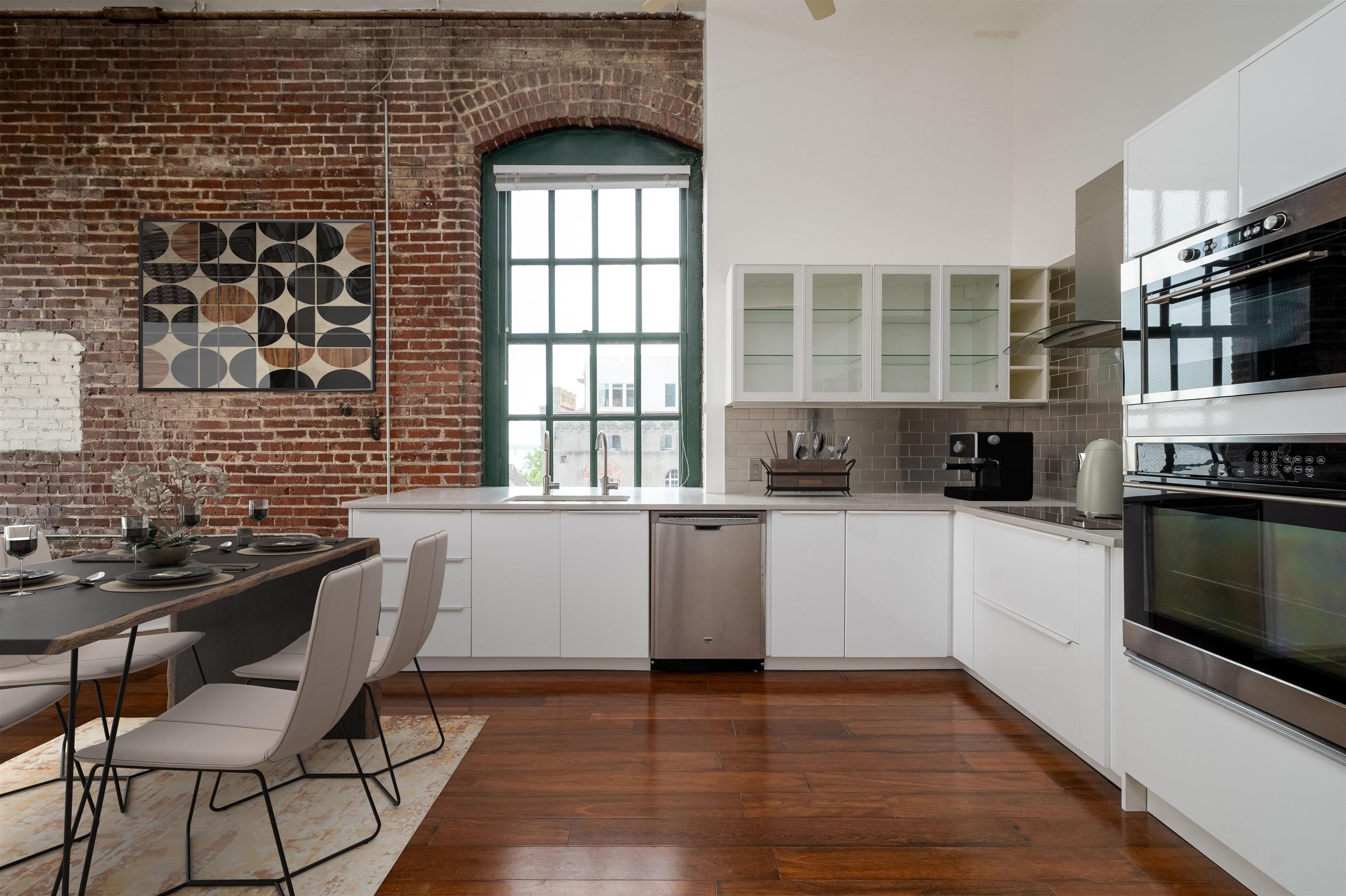 505 Tennessee Street, Unit 428 Memphis, TN 38103 - Photo 9 of 29 a kitchen with stainless steel appliances a stove a sink a microwave and cabinets
