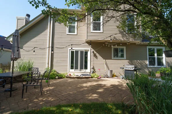 a view of a house with a yard and sitting area