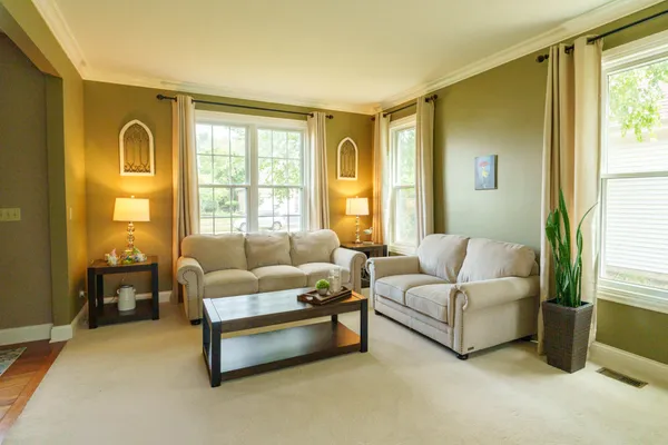 a living room with furniture and a large window