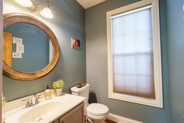 a bathroom with a sink mirror vanity and a toilet