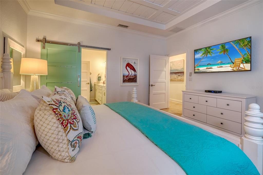 13511 Gulf Boulevard Madeira Beach, FL 33708 - Photo 12 of 30 a bedroom with a bed and a dresser