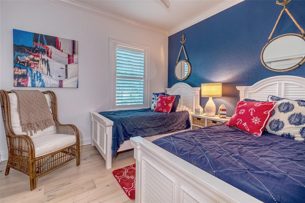 13511 Gulf Boulevard Madeira Beach, FL 33708 - Photo 14 of 30 a bedroom with a bed and window