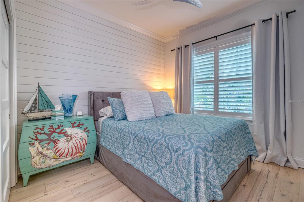 13511 Gulf Boulevard Madeira Beach, FL 33708 - Photo 17 of 30 a bedroom with a bed and window