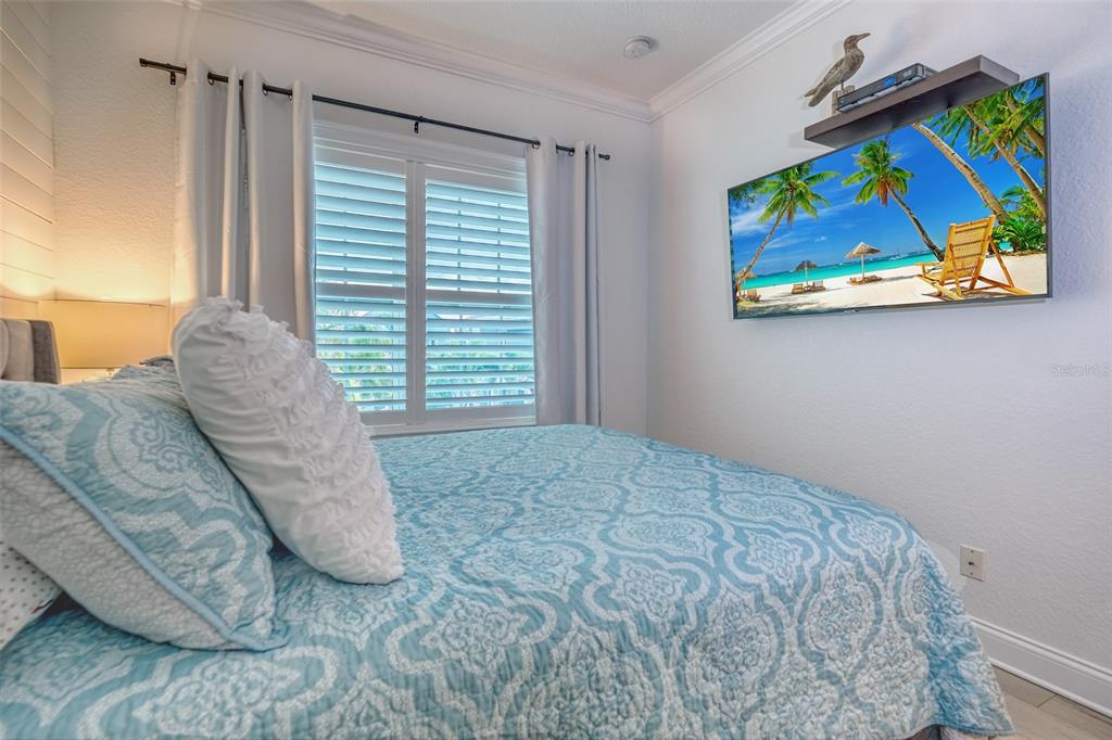 13511 Gulf Boulevard Madeira Beach, FL 33708 - Photo 18 of 30 a view of a bedroom with furniture and window