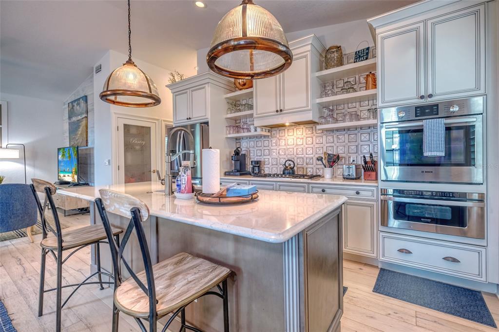 13511 Gulf Boulevard Madeira Beach, FL 33708 - Photo 2 of 30 a open kitchen with stainless steel appliances granite countertop a stove and a wooden cabinets