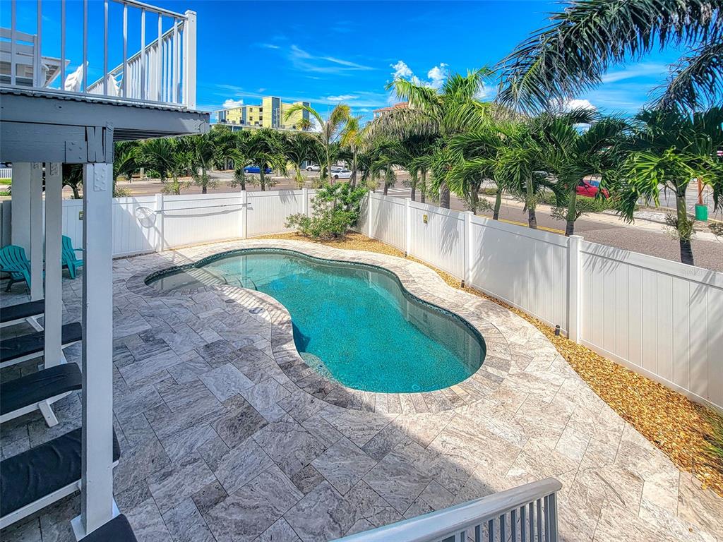 13511 Gulf Boulevard Madeira Beach, FL 33708 - Photo 26 of 30 a view of a swimming pool with a patio