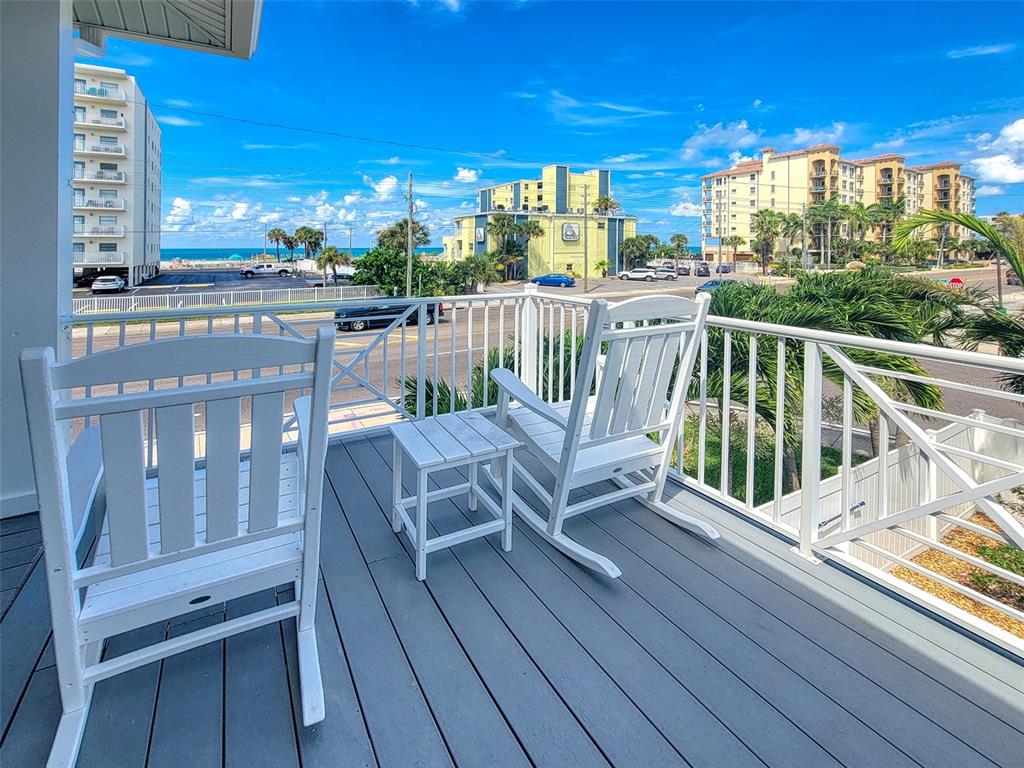 13511 Gulf Boulevard Madeira Beach, FL 33708 - Photo 28 of 30 a view of a balcony with wooden chairs