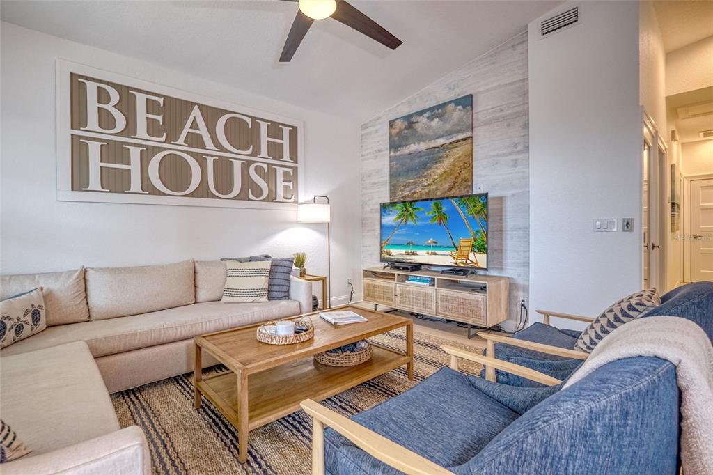 13511 Gulf Boulevard Madeira Beach, FL 33708 - Photo 9 of 30 a living room with furniture and a flat screen tv