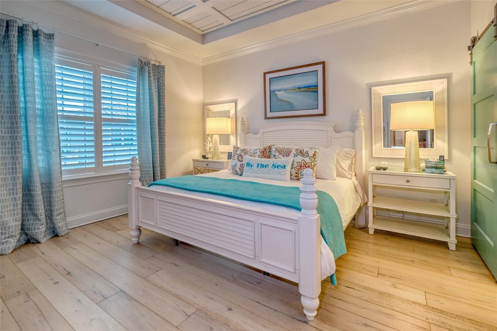 13511 Gulf Boulevard Madeira Beach, FL 33708 - Photo 10 of 30 a bedroom with furniture and a wooden floor