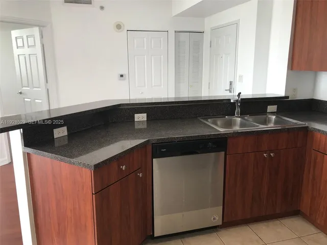 a kitchen with a sink and cabinets