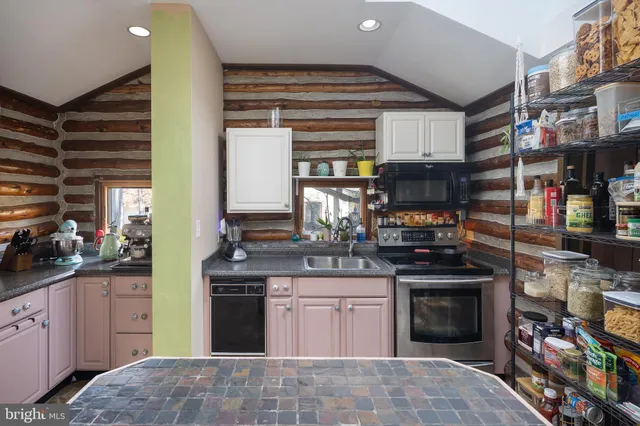 a kitchen with stainless steel appliances a stove sink and refrigerator