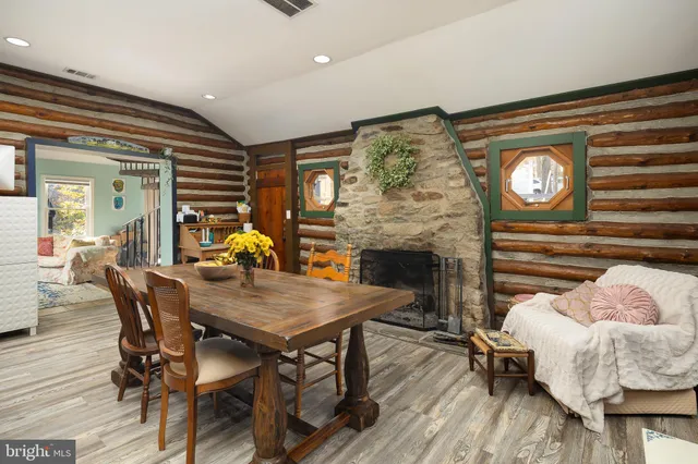a dining room with furniture and wooden floor