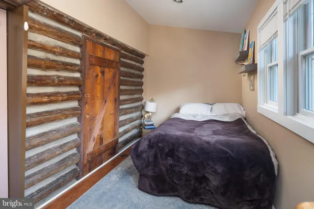 a bed sitting in a bedroom next to a window