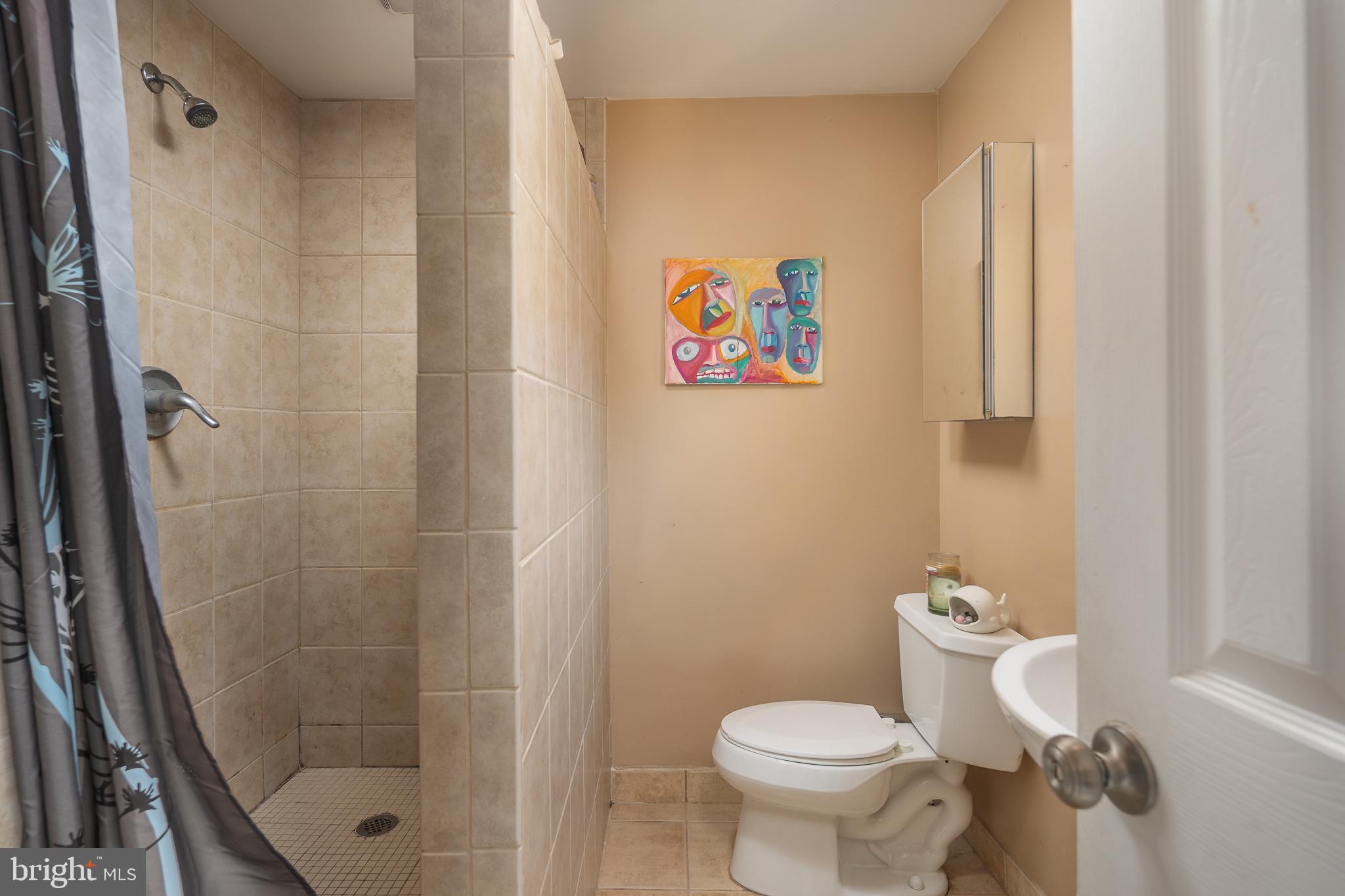 11999 Manning Road Manassas, VA 20112 - Photo 26 of 76 a bathroom with a toilet and a shower curtain