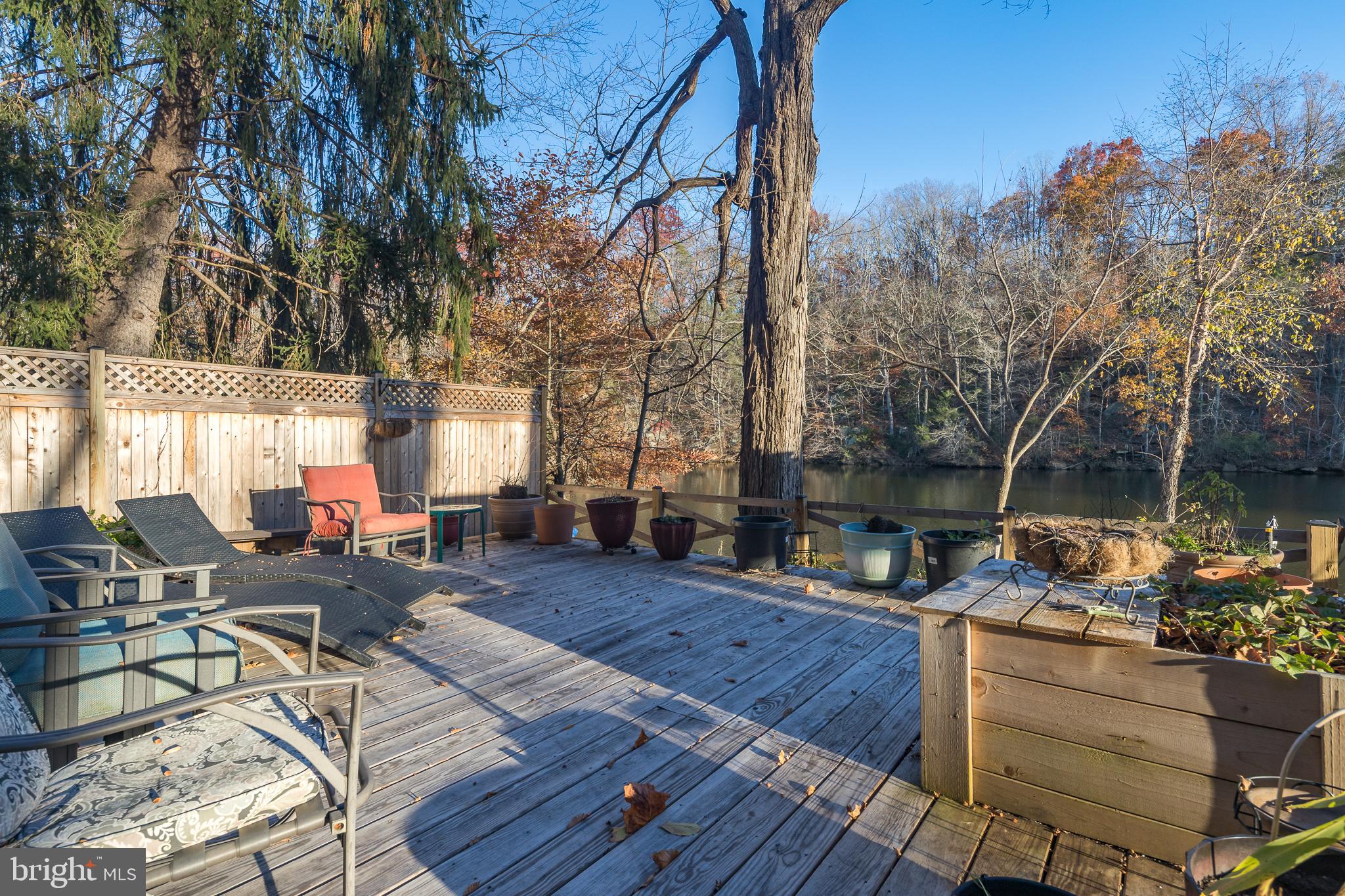 11999 Manning Road Manassas, VA 20112 - Photo 30 of 76 a view of a patio with couches table and chairs with wooden floor and fence