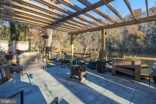 a view of swimming pool with a yard and large trees