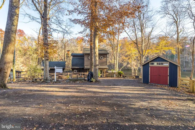 a view of a red house with a large tree in front of it