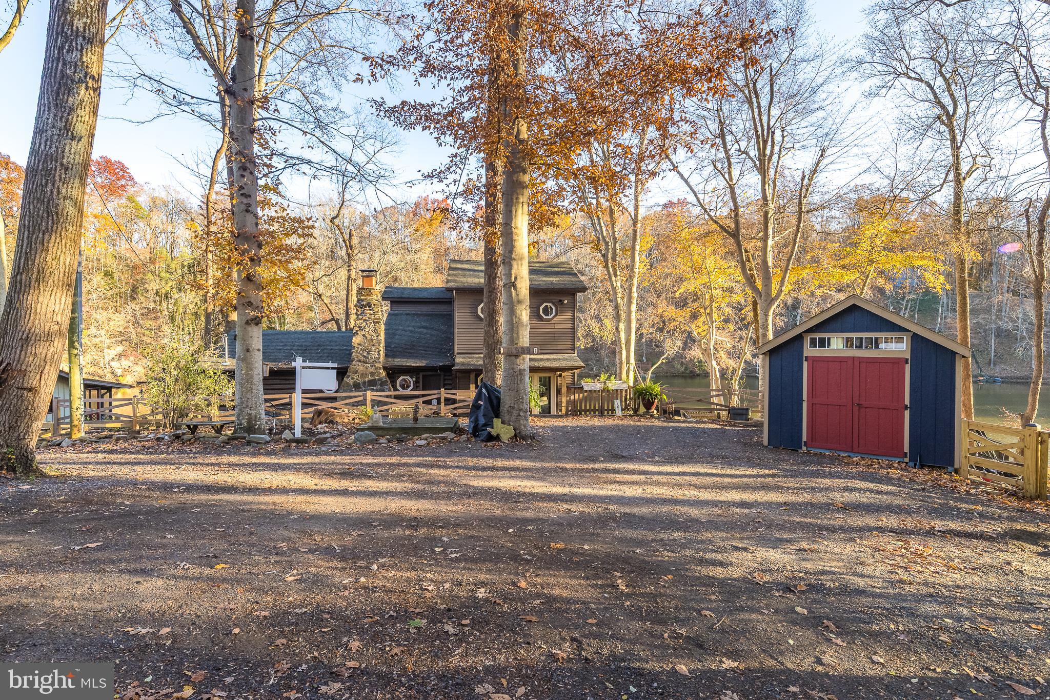 11999 Manning Road Manassas, VA 20112 - Photo 5 of 76 a view of a red house with a large tree in front of it