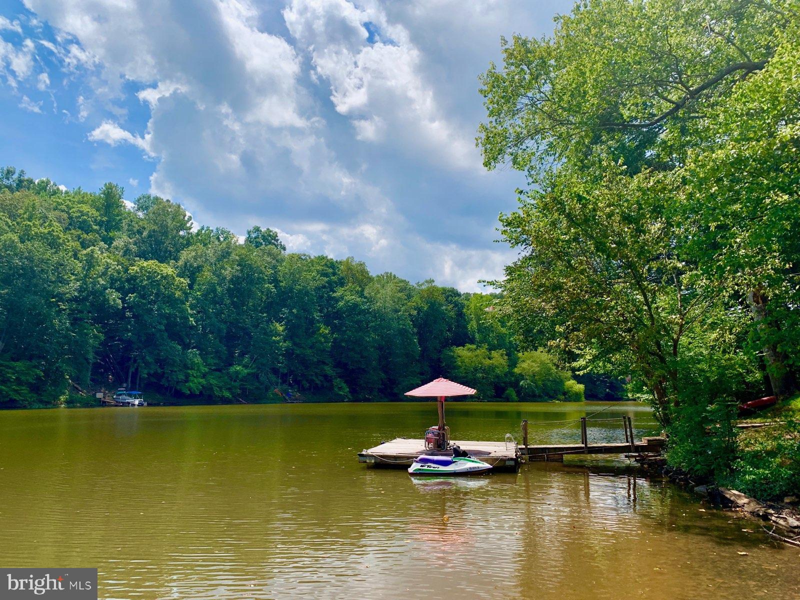 11999 Manning Road Manassas, VA 20112 - Photo 52 of 76 a view of swimming pool with lawn chairs under an umbrella