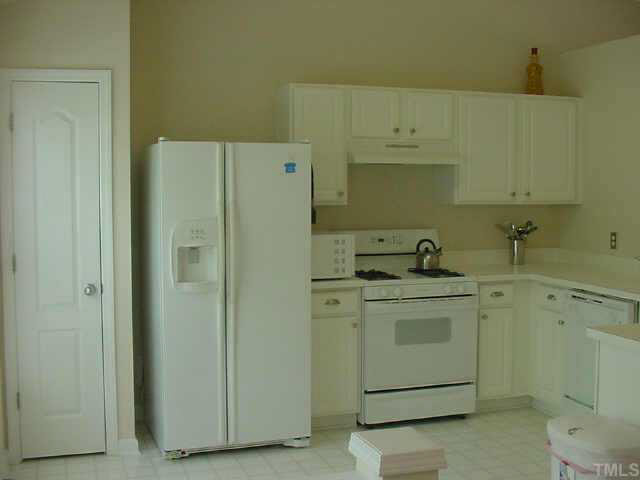 4808 Loganshire Lane Raleigh, NC 27616 - Photo 5 of 10 YOur kitchen is sunny and bright with a pantry and pass through... great for entertaining both family and friends!