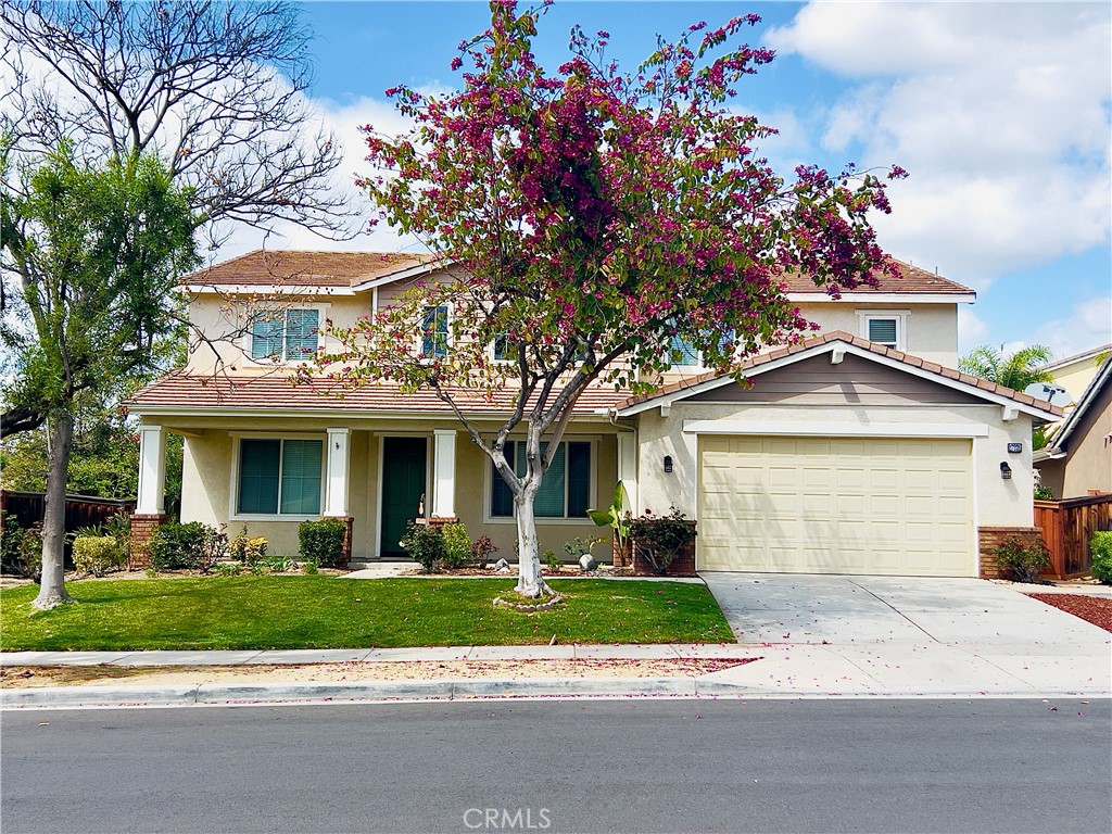 a front view of a house with a yard and a garage