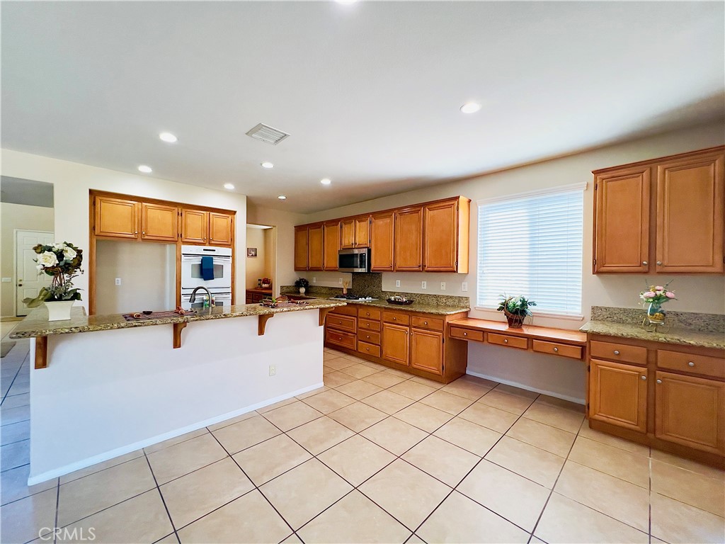 17231 Greentree Drive Riverside, CA 92503 - Photo 11 of 42 a large kitchen with stainless steel appliances lots of counter top space