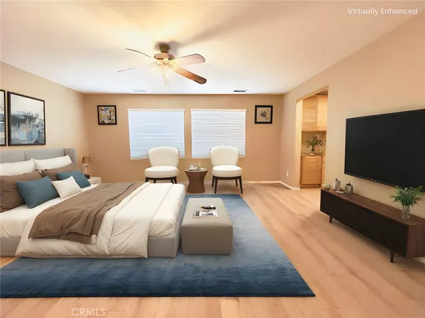 a bedroom with a bed window and a flat screen tv