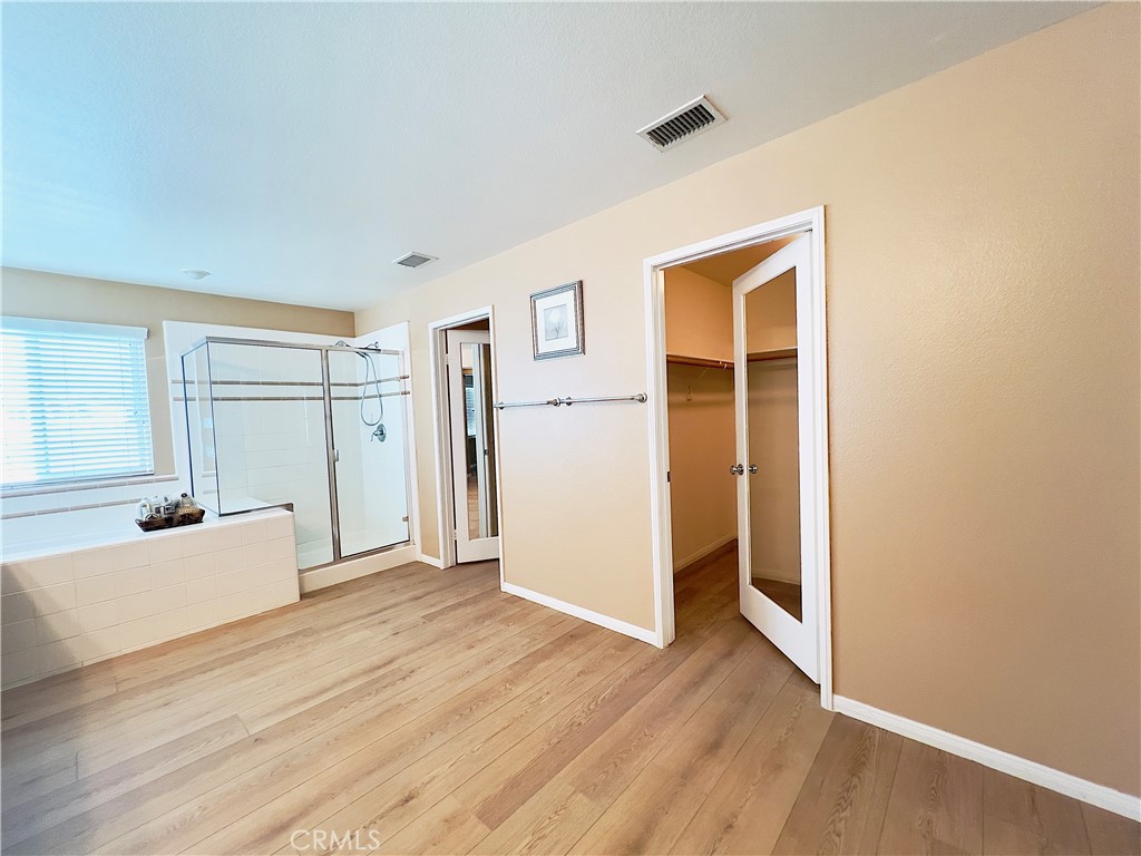 17231 Greentree Drive Riverside, CA 92503 - Photo 21 of 42 an empty room with wooden floor and windows