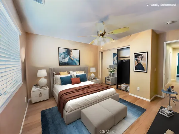 a bedroom with a large bed couch and a window