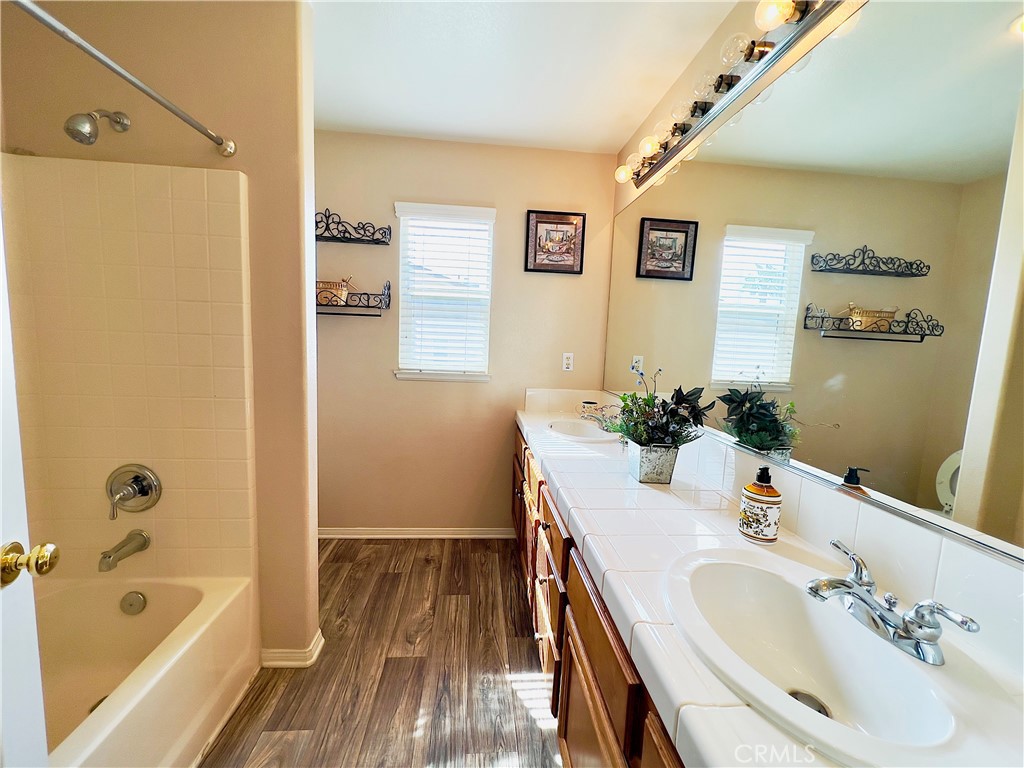 17231 Greentree Drive Riverside, CA 92503 - Photo 26 of 42 a bathroom with a tub sink and mirror
