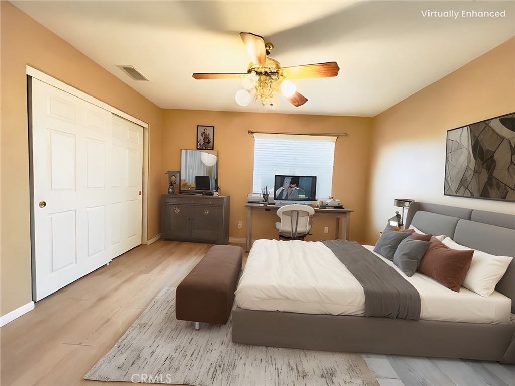 17231 Greentree Drive Riverside, CA 92503 - Photo 31 of 42 a bedroom with a large bed and a chandelier