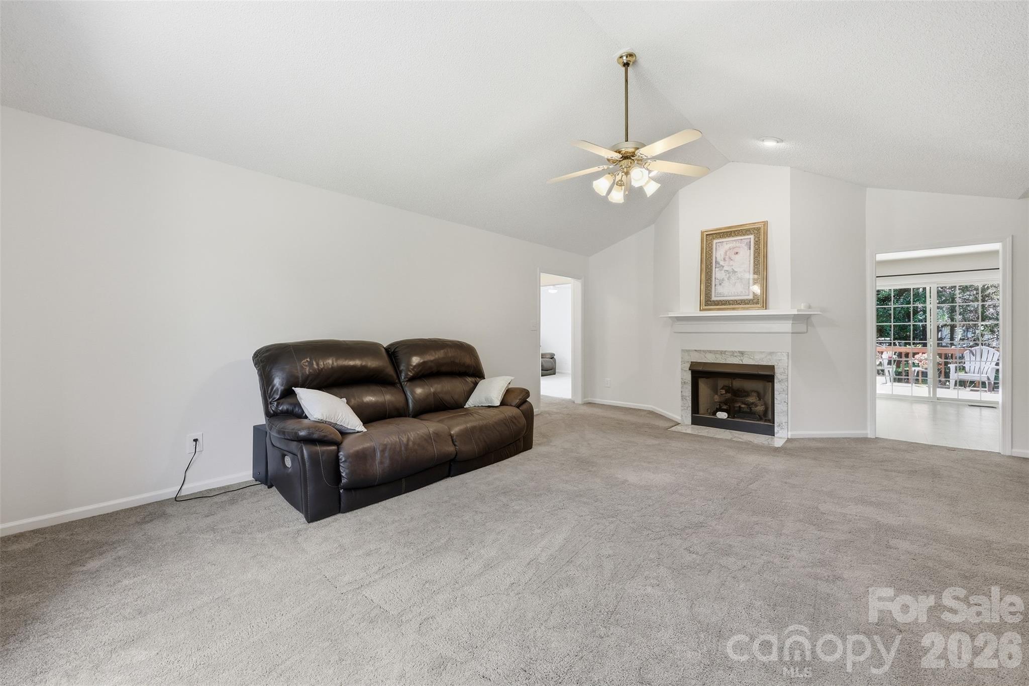 913 Pleasant Ridge Road Fort Mill, SC 29715 - Photo 7 of 40 a living room with furniture a fireplace and a chandelier