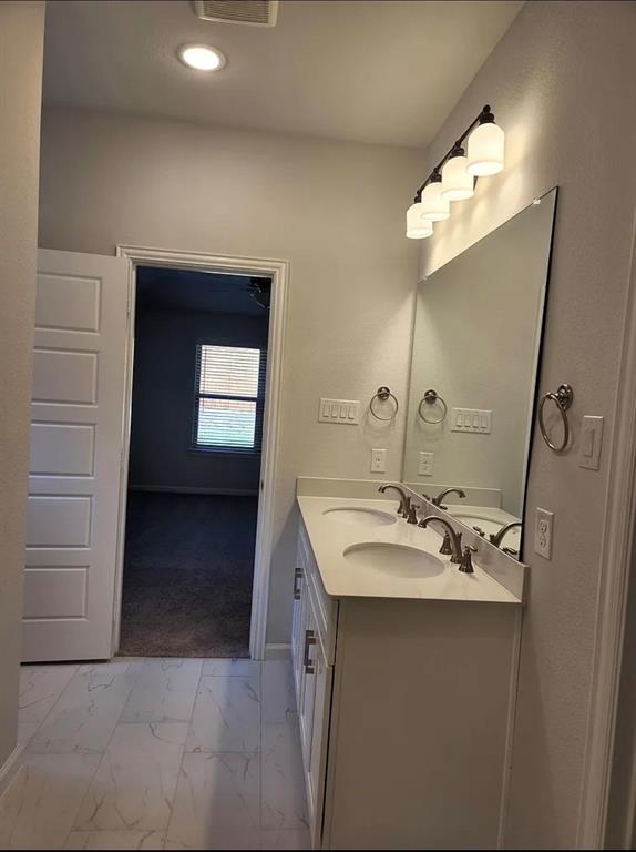 2043 Atlantic Avenue Anna, TX 75409 - Photo 19 of 25 a bathroom with a sink and a mirror