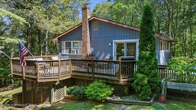 a view of a house with a small yard and wooden fence