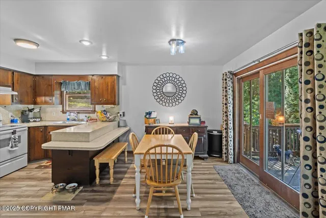 a view of a kitchen with kitchen island granite countertop a sink and a refrigerator