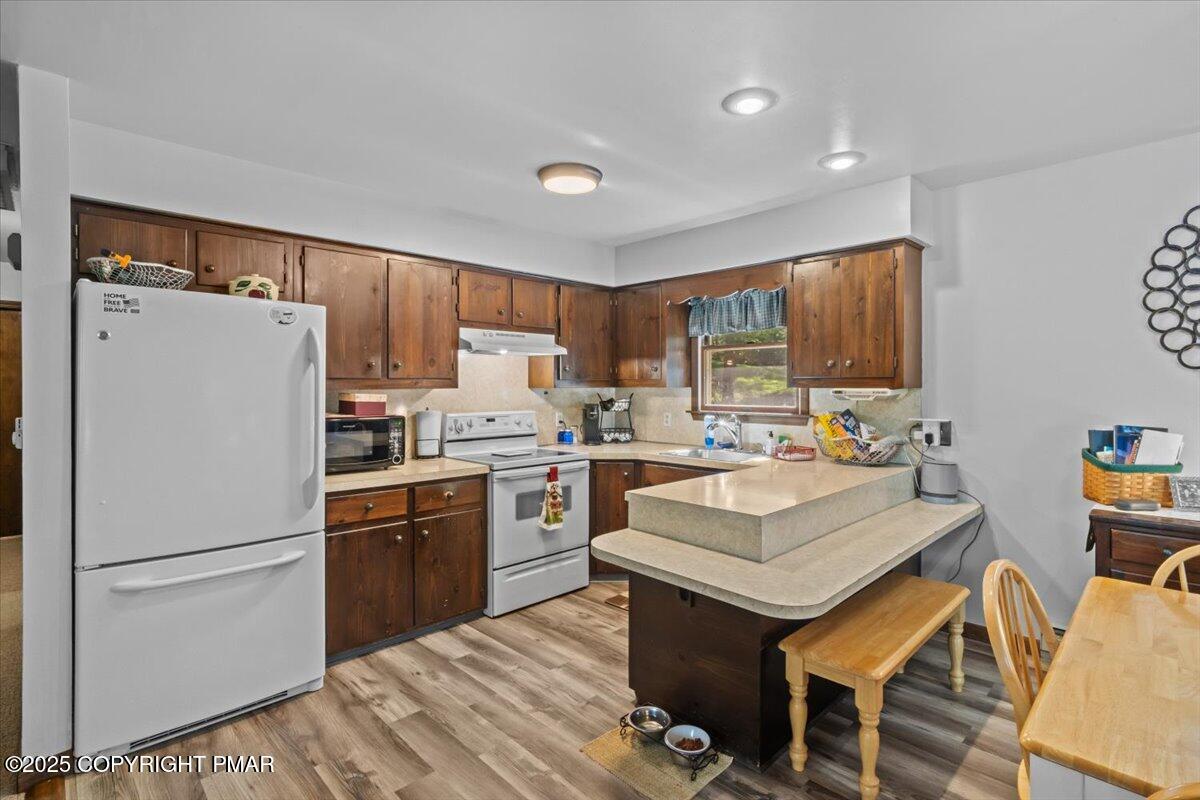 157 Viewtop Road Palmerton, PA 18071 - Photo 6 of 22 a kitchen with a refrigerator a sink a stove a dining table and chairs