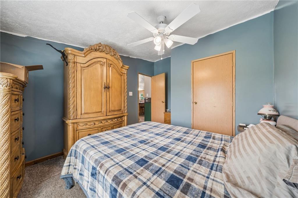 275 Adamik Road Clarksville, PA 15322 - Photo 20 of 39 a bedroom with a bed and a chandelier