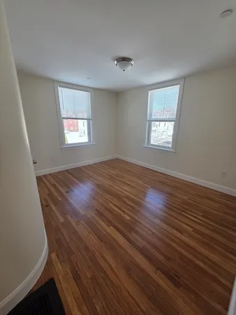 a view of room with window and hardwood floor
