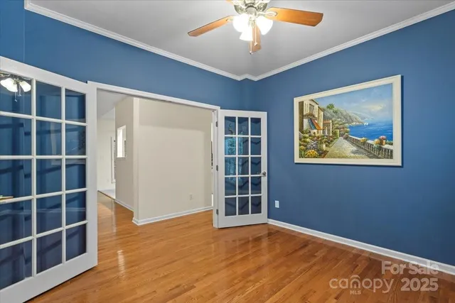 a view of a livingroom with wooden floor a fireplace and window